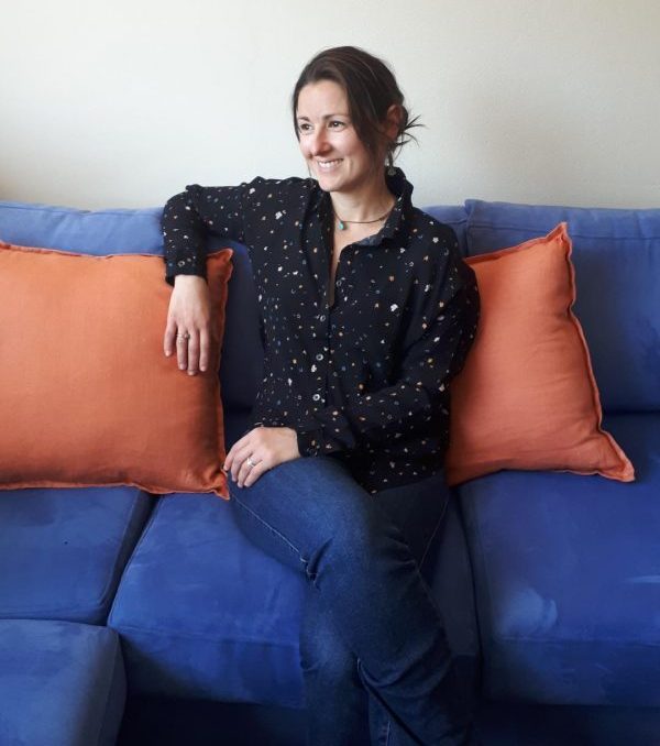 Dani sitting on sofa